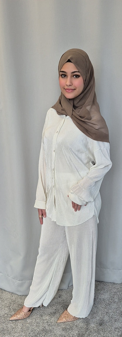 A woman wearing the Bihi Boutique Stylish Black Opal Co-ord Set (Fashionable One Size) stands on a gray carpet before a light gray curtain, smiling confidently with one hand on her hip.