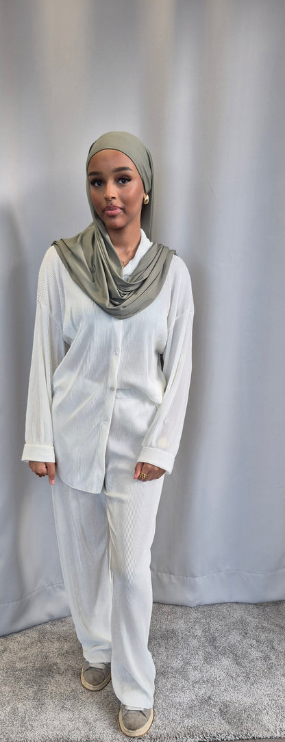 A woman stands on a gray carpet before a plain gray curtain, wearing the Bihi Boutique Shop Stylish Black Opal Co-ord Set—an oversized, fashionable one size outfit.
