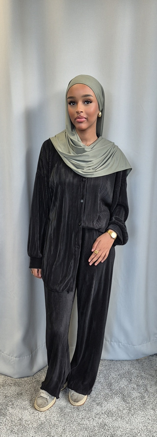 A woman models the Bihi Boutique Shop Stylish Black Opal Co-ord Set (Fashionable One Size), paired with a light gray hijab, standing before a gray curtain and carpeted floor, her hand at her side with a watch on her wrist.