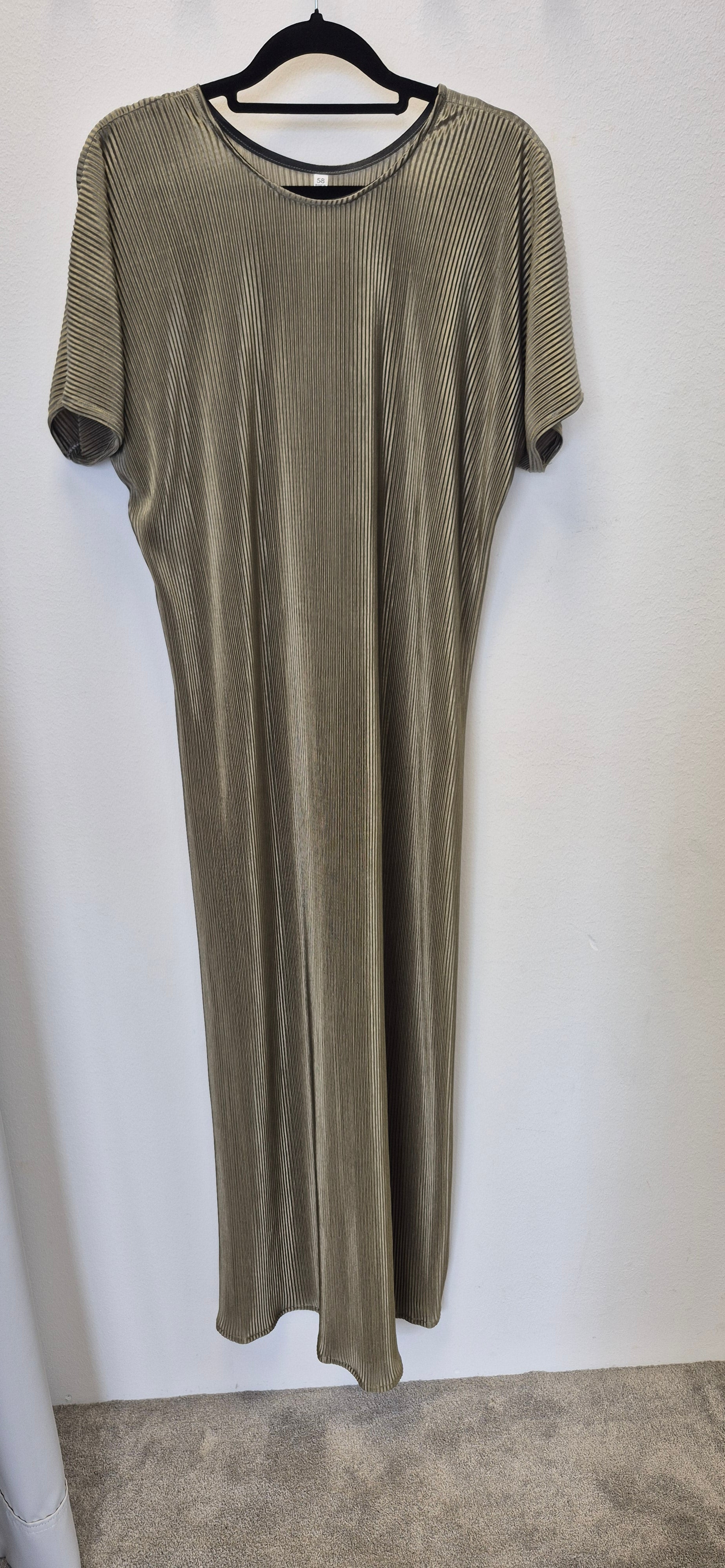The Zaytun Slip Dress by Bihi Boutique in size 58 features short sleeves, ankle length, a loose fit, and vertical ribbed texture in light olive or taupe, shown on a black hanger against a white wall—effortless elegance for any occasion.