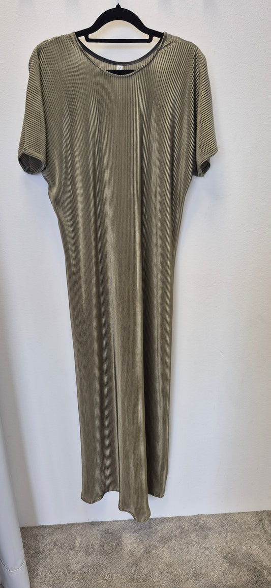 The Zaytun Slip Dress by Bihi Boutique in size 58 features short sleeves, ankle length, a loose fit, and vertical ribbed texture in light olive or taupe, shown on a black hanger against a white wall—effortless elegance for any occasion.